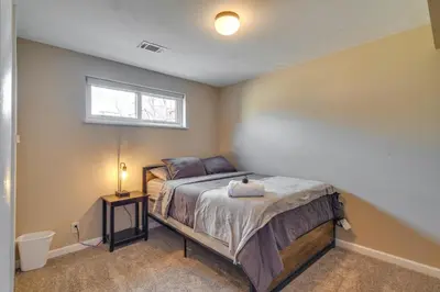 a bedroom with a bed and a window at 2 Mi to Olde Town! Pet-Friendly Haven with Sunroom in Arvada