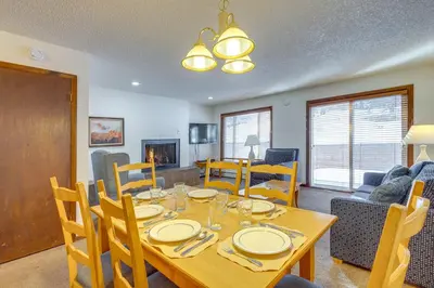 a dining room and living room with a table and chairs at Heated Pool Access at Winter Park Base Camp! in Winter Park