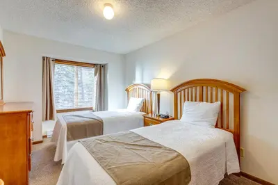 a hotel room with two beds and a window at Heated Pool Access at Winter Park Base Camp! in Winter Park