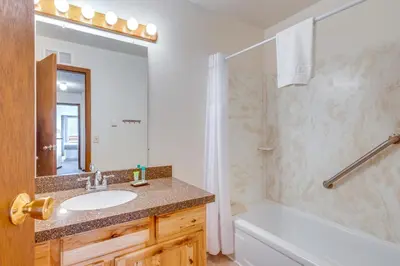 a bathroom with a sink and a toilet and a tub at Heated Pool Access at Winter Park Base Camp! in Winter Park