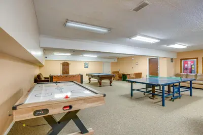 a room with two ping pong tables in it at Heated Pool Access at Winter Park Base Camp! in Winter Park