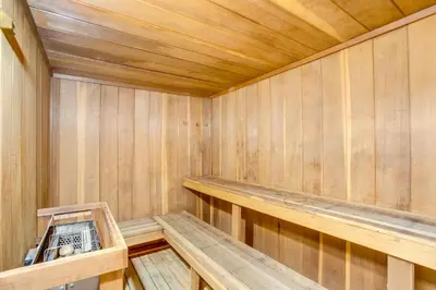 an empty wooden sauna with a bench in it at Walk to Main St! Ultimate Winter Park Getaway in Winter Park