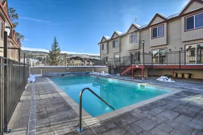 a swimming pool in front of a building at Walk to Main St! Ultimate Winter Park Getaway in Winter Park