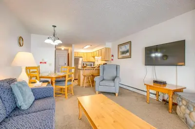 a living room with a couch and a dining room at Heated Pool and Hot Tub! Winter Park Mtn Retreat in Winter Park