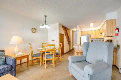 a living room with a couch and a dining room at Heated Pool and Hot Tub! Winter Park Mtn Retreat in Winter Park