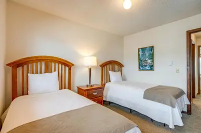 a hotel room with two beds and a lamp at Heated Pool and Hot Tub! Winter Park Mtn Retreat in Winter Park