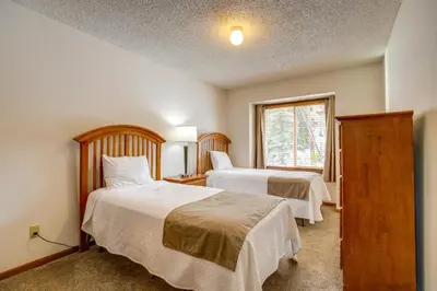 a bedroom with two beds and a window at Pool and Hot Tub! Hub for All-Season Winter Park Fun in Winter Park