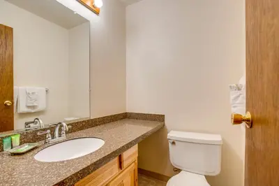 a bathroom with a sink and a toilet at Pool and Hot Tub! Hub for All-Season Winter Park Fun in Winter Park