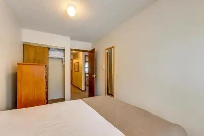 a bedroom with a bed and a door to a hallway at Pool and Hot Tub! Hub for All-Season Winter Park Fun in Winter Park