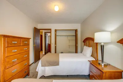 a bedroom with a bed and a dresser and a mirror at Pool and Hot Tub! Hub for All-Season Winter Park Fun in Winter Park