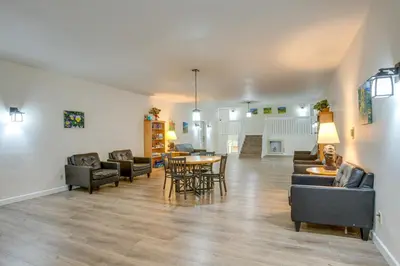 a living room with couches and a table and chairs at Pool and Hot Tub! Hub for All-Season Winter Park Fun in Winter Park