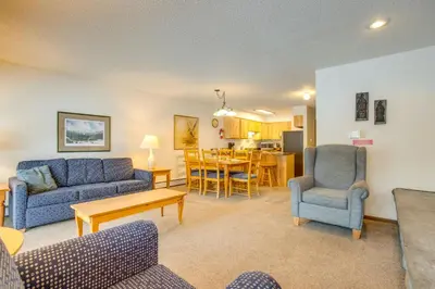 a living room with two blue couches and a table at Heated Pool and Hot Tubs at Dtwn Winter Park Condo! in Winter Park