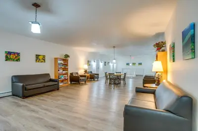 a living room with leather furniture and a dining room at Heated Pool and Hot Tubs at Dtwn Winter Park Condo! in Winter Park
