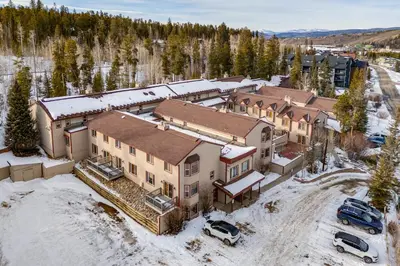 an aerial view of a large house in the snow at Heated Pool and Hot Tubs at Dtwn Winter Park Condo! in Winter Park