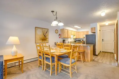 a kitchen and dining room with a table and chairs at Heated Pool and Hot Tubs at Dtwn Winter Park Condo! in Winter Park