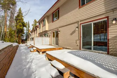 a building with snow covered benches outside of it at 3 Mi to Winter Park Slopes! Unit with Pool and Hot Tub in Winter Park