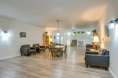 a living room with couches and a table and chairs at 3 Mi to Winter Park Slopes! Unit with Pool and Hot Tub in Winter Park
