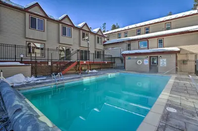 a swimming pool in front of a building at 3 Mi to Winter Park Slopes! Unit with Pool and Hot Tub in Winter Park