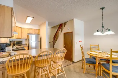 a kitchen and dining room with a table and chairs at 3 Mi to Winter Park Slopes! Unit with Pool and Hot Tub in Winter Park
