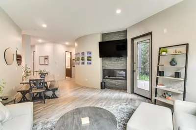a living room with a couch and a table at Ski-InandSki-Out! Winter Park Family Gem with Hot Tub in Winter Park