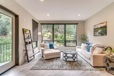 a living room with two couches and a table at Ski-InandSki-Out! Winter Park Family Gem with Hot Tub in Winter Park