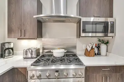 a kitchen with a stove and a microwave at Ski-InandSki-Out! Winter Park Family Gem with Hot Tub in Winter Park