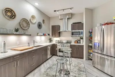 a kitchen with wooden cabinets and stainless steel appliances at Ski-InandSki-Out! Winter Park Family Gem with Hot Tub in Winter Park
