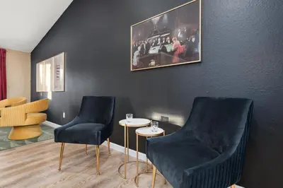 two chairs and a table in a room at Backyard Movie, Hot Tub & 2 Game Rooms in Arvada