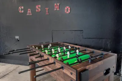 a foos ball in a wooden box in a room at Backyard Movie, Hot Tub & 2 Game Rooms in Arvada