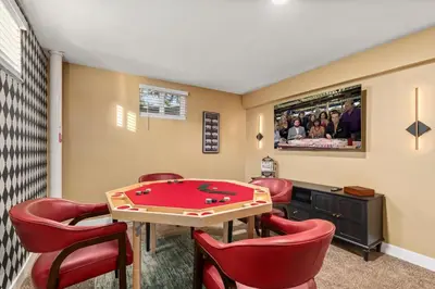a game room with a pool table and red chairs at Backyard Movie, Hot Tub & 2 Game Rooms in Arvada