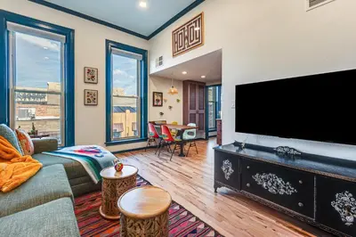 a living room with a large flat screen tv at Shop, Dine, Unwind! Couples Retreat in Dtwn Golden in Golden
