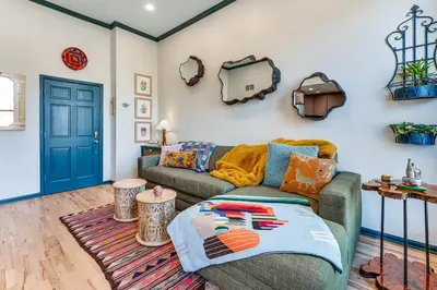 a living room with a couch and a blue door at Shop, Dine, Unwind! Couples Retreat in Dtwn Golden in Golden