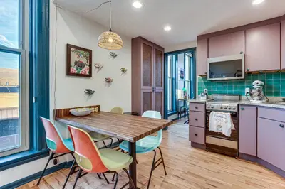 a kitchen and dining room with a wooden table and chairs at Shop, Dine, Unwind! Couples Retreat in Dtwn Golden in Golden