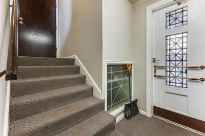 a staircase in a house with a door and a cat at Shop, Dine, Unwind! Couples Retreat in Dtwn Golden in Golden