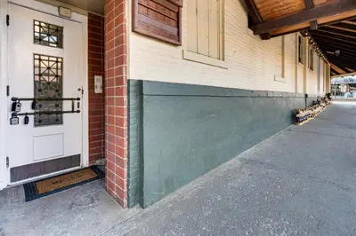 a green garage door on the side of a building at Shop, Dine, Unwind! Couples Retreat in Dtwn Golden in Golden
