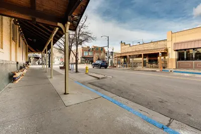 an empty city street with a blue line on the road at Shop, Dine, Unwind! Couples Retreat in Dtwn Golden in Golden