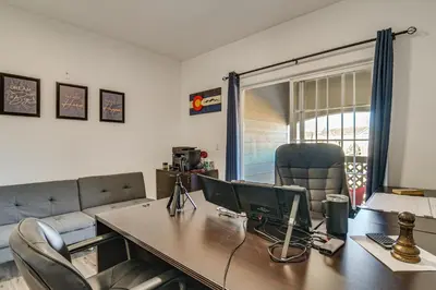 an office with a desk with a computer on it at WFH Setup and Garage Parking! Modern Denver Condo in Thornton