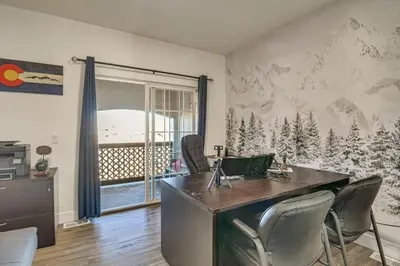 an office with a desk and chairs in a room at WFH Setup and Garage Parking! Modern Denver Condo in Thornton