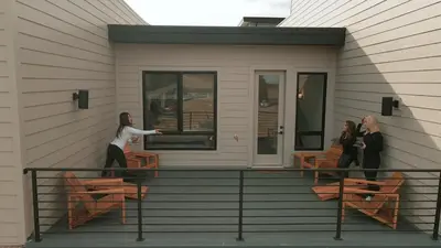 two women standing on the balcony of a house at New TownHome Downtown Westminster 4-6 Guests in Westminster