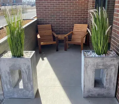 two concrete vases with plants in them on a patio at New TownHome Downtown Westminster 4-6 Guests in Westminster
