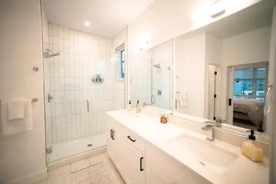 a bathroom with a sink and a shower and a mirror at New TownHome Downtown Westminster 4-6 Guests in Westminster