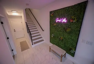 a room with a green wall with a bench and stairs at New TownHome Downtown Westminster 4-6 Guests in Westminster