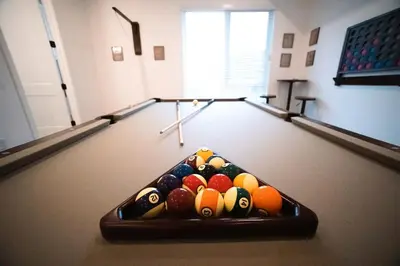 a room with a pool table with cue balls at New TownHome Downtown Westminster 4-6 Guests in Westminster
