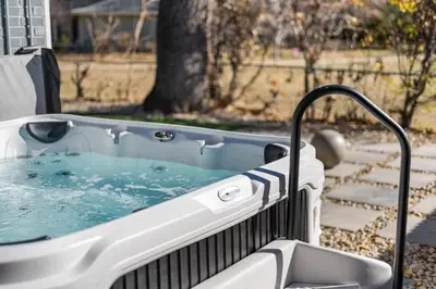 a jacuzzi tub sitting in a yard at NEW Olde Town Arvada 5BR Luxe Mini Golf Hot Tub Arcade Cinema Gym in Arvada