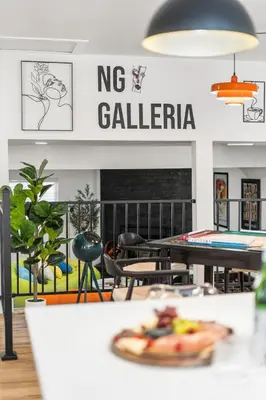 a restaurant with tables and chairs and a sign that reads np galeria at NEW Olde Town Arvada 5BR Luxe Mini Golf Hot Tub Arcade Cinema Gym in Arvada