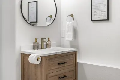 a bathroom with a sink and a mirror at NEW Olde Town Arvada 5BR Luxe Mini Golf Hot Tub Arcade Cinema Gym in Arvada