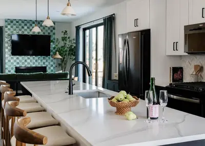 a kitchen with a sink and a counter with wine glasses at Luxury 5BR - Hot Tub - Game Garage - Mini Golf in Denver