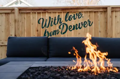 a blue couch sitting in front of a fire at Luxury 5BR - Hot Tub - Game Garage - Mini Golf in Denver