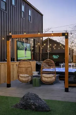 a patio with two chairs and a television on at Luxury 5BR - Hot Tub - Game Garage - Mini Golf in Denver