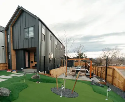a black house with a playground in front of it at Luxury 5BR - Hot Tub - Game Garage - Mini Golf in Denver